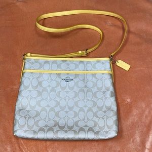 Yellow accented Coach cross over bag. Long adjustable shoulder strap.